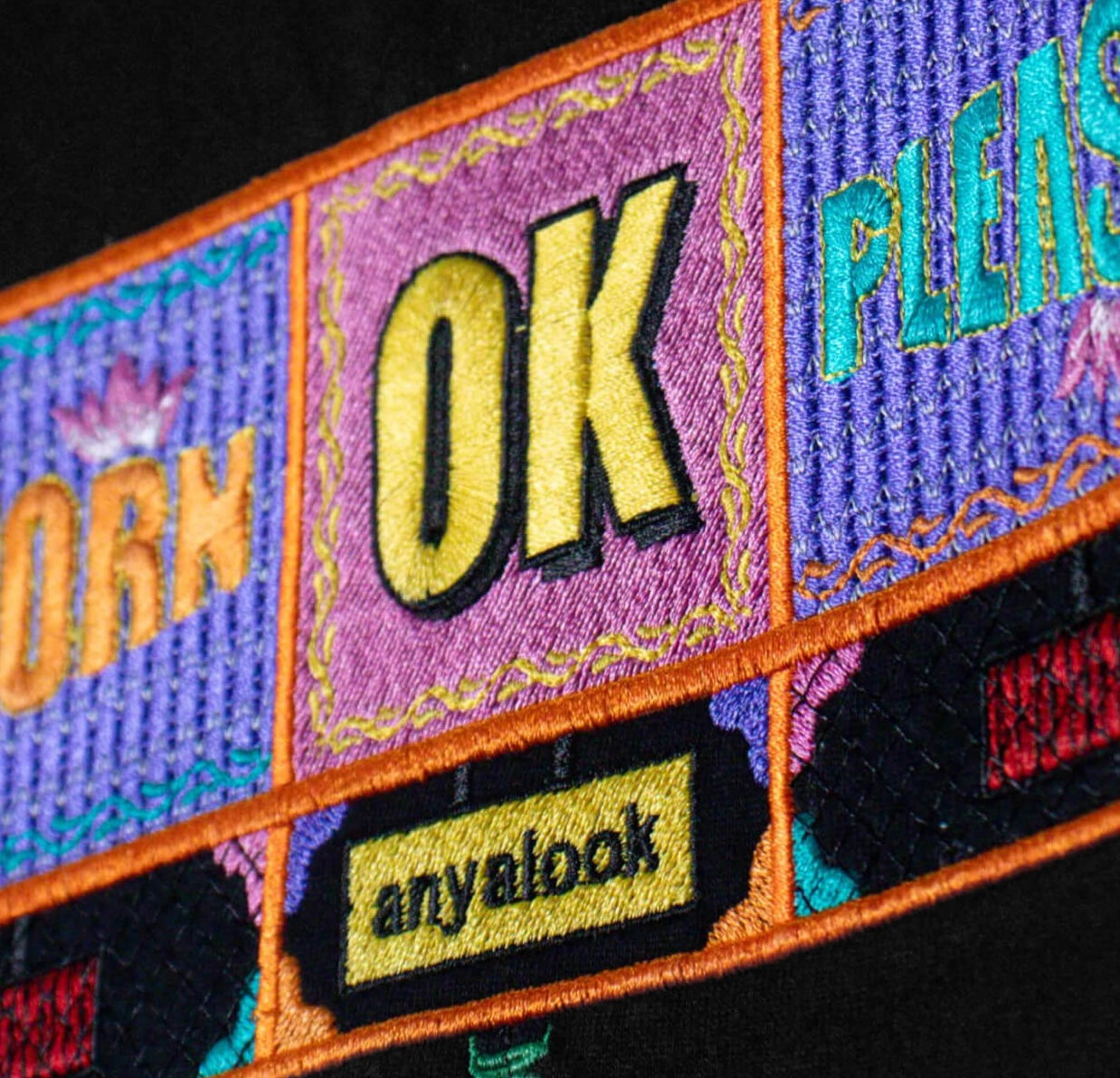 Colorful embroidery truck back design  with text and brand name on a black background